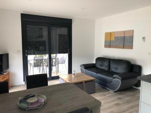 a living room with a black couch and a table at LA CASA DE FRANCOIS in Oraison
