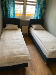 Llit o llits en una habitació de Apartament Wiosełko Warszawa