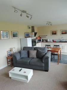 a living room with a couch and a table at The Studio in Georgeham