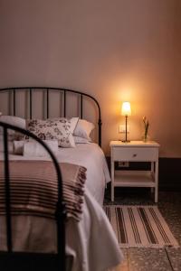 a bedroom with a bed and a table with a lamp at Locanda agricola Posapiano in Montecarlo