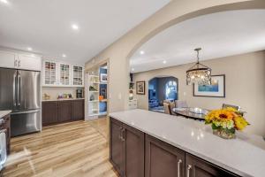 a large kitchen with a counter top and a dining room at Luxury Apartment in Historic Carriage House in Kennett Square