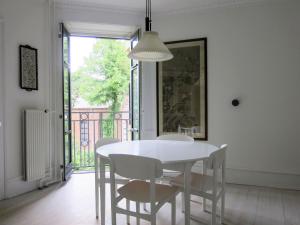 a white dining room with a white table and chairs at ApartmentInCopenhagen Apartment 1389 in Copenhagen