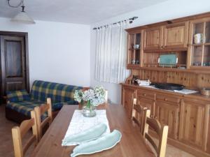 a dining room with a table and a couch at Agriturismo il canale in Corfino