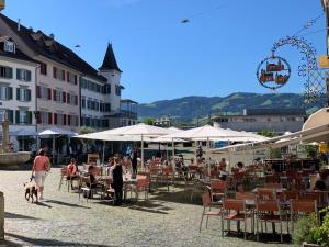 a group of people sitting at tables and chairs at Old Town Loft & Central Location in Rapperswil in Rapperswil-Jona