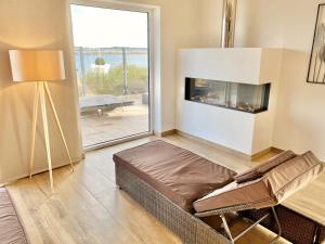 a living room with a couch and a fireplace at mönchgut living & spa in Gager