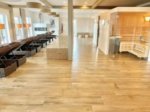 a hallway in a building with wooden floors and benches at mönchgut living & spa in Gager