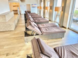 a row of brown chairs in a waiting room at mönchgut living & spa in Gager