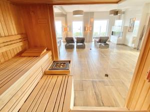 a room with a fireplace in the middle of a building at mönchgut living & spa in Gager