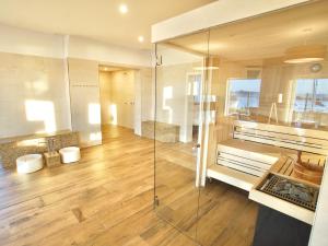 a bathroom with a glass shower and a sink at mönchgut living & spa in Gager