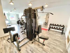 a gym with several treadmills and cardio machines at mönchgut living & spa in Gager