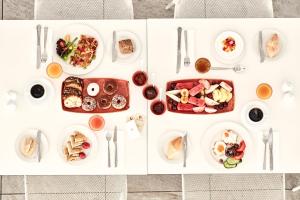 a white table with plates of food on it at Atlantica Aeneas Resort in Ayia Napa