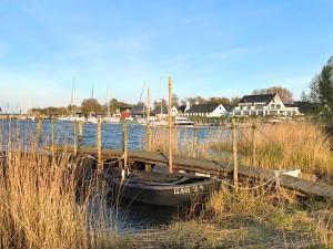 a small boat is docked next to a dock at mönchgut living & spa in Gager