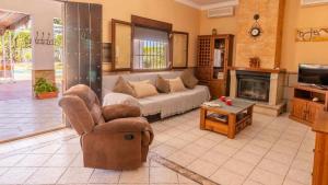 a living room with a couch and a fireplace at Casa Rural Silvia y Melissa in La Puebla de Cazalla