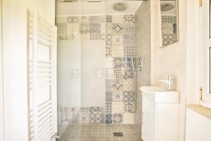 a bathroom with a shower with a toilet and a sink at Ypa Home Lago di Candia Canavese in Candia Canavese