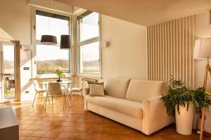 a living room with a couch and a table at Ypa Home Lago di Candia Canavese in Candia Canavese