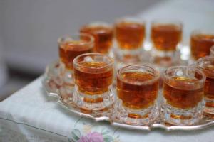 a tray of glasses of honey on a table at Balla Mama, Hajdúszoboszló in Hajdúszoboszló