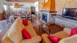 a living room with a couch and a fireplace at Casa Rural Villa Paquita in La Lantejuela