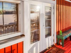 a front door of a house with a bench on it at Holiday Home Juurlahti by Interhome in Hara