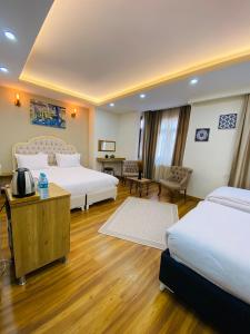 a large hotel room with two beds and a television at PALMERA OLD CITY in Istanbul