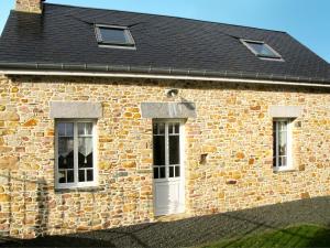 a brick house with two windows and a white door at Holiday Home Zoé - CEZ407 by Interhome in Créances