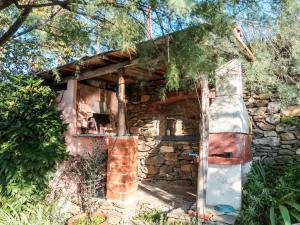 a stone house with a fireplace in a forest at Apartment Casina - VDE211 by Interhome in Arnasco