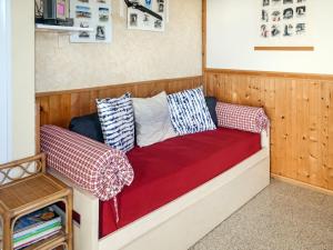 a couch with pillows on it in a room at Apartment Casina - VDE211 by Interhome in Arnasco