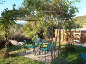 a patio with a table and chairs under a gazebo at Apartment Casina - VDE211 by Interhome in Arnasco