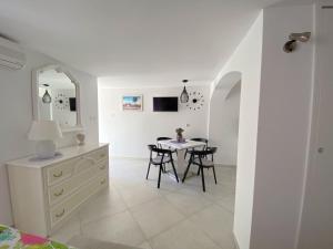 a dining room with a table and a dresser at Guest House Meri in Bol