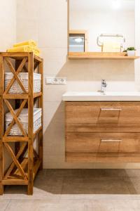 a bathroom with a sink and a shelf with towels at Apartment Michi - MHO631 by Interhome in Schwendau