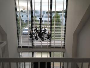 a large window with a chandelier in a room at Holiday Home in Zeewolde with Jetty next to golf course in Zeewolde