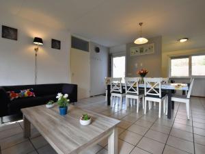 uma sala de estar com uma mesa e uma sala de jantar em Appealing Holiday Home in Guelders near Forest em Lochem