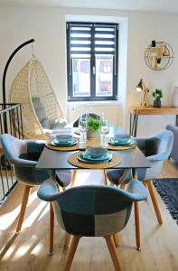 a dining room with a table and chairs at Le temps d'un rêve, prestige, détente au centre ville. in Molsheim