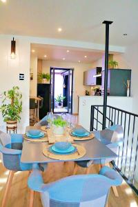 a dining room table with blue dishes on it at Le temps d'un rêve, prestige, détente au centre ville. in Molsheim