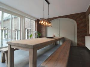 a dining room with a wooden table and a bench at Tranquil Holiday Home in Platja d'Aro with bubble bath in Swolgen