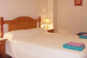 a bedroom with a bed with two towels on it at Apartamento en primera linea para 4 personas in Port de Pollensa