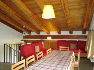 a dining room with a table and red chairs at Chalet Casot Brusa - SMY101 by Interhome in Sampeire