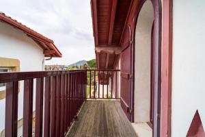 a balcony of a house with an open door at MAGNOLIAS 2- quartier résidentiel proche de la plage in Hendaye