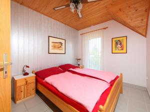 a bedroom with a bed and a ceiling fan at Holiday Home Freesia by Interhome in Fonyód
