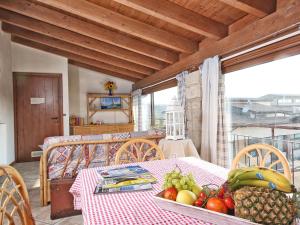 a table with a bowl of fruit on top of a room at Apartment Colombaro Vecchio-7 by Interhome in San Felice del Benaco