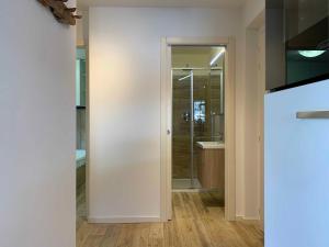 a bathroom with a shower and a glass door at Bilocale Mandron 105 in Madonna di Campiglio