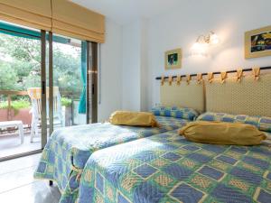 a bedroom with two beds and a balcony at Apartment Els Pins Maria by Interhome in Torredembarra