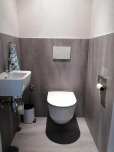 ein Badezimmer mit einem weißen WC und einem Waschbecken in der Unterkunft Landhaus Lindner Appartements in Fügen