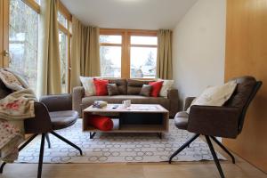 a living room with a couch and two chairs at Bad Kleinkirchheim RMG family apartments in Bad Kleinkirchheim
