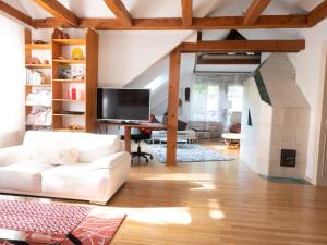 a living room with a white couch and a tv at Apartment Villa Marie by Interhome in Purkersdorf