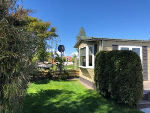 a house with a yard with green grass at Holiday Home Wiringherlant-2 by Interhome in Hippolytushoef