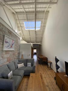 a living room with a couch and a table at Buckingham Place at the Royal William Yard in Plymouth