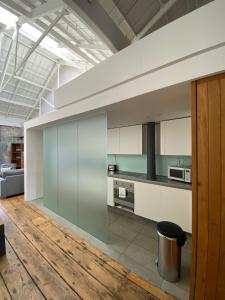 a kitchen with a large glass wall in a room at Buckingham Place at the Royal William Yard in Plymouth