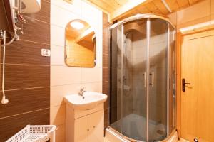 a bathroom with a shower and a sink at Marina in Jarosławiec +19 photos