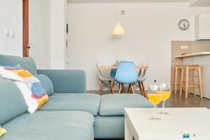 a living room with a blue couch and a table at Mljet 4 You - seafront apartment in Sobra