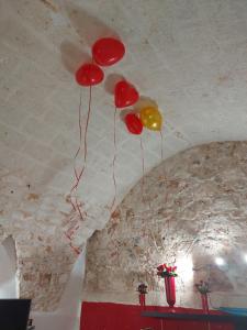 Ein Haufen roter und gelber Ballons hängt an der Decke in der Unterkunft Buze Rodriguez Suite in Ostuni